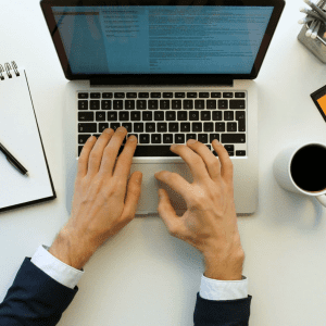 videoblocks business man typing on laptop keyboard in office hands top view working on white office desk with orange details hzos