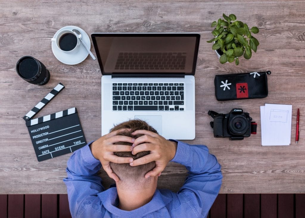 frustrated man with macbook photo